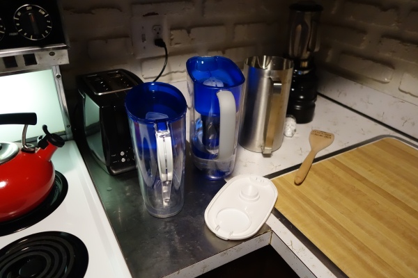 Tools of victory - one uncovered drinks pitcher, two covered and filtered water pitchers, and a spatula